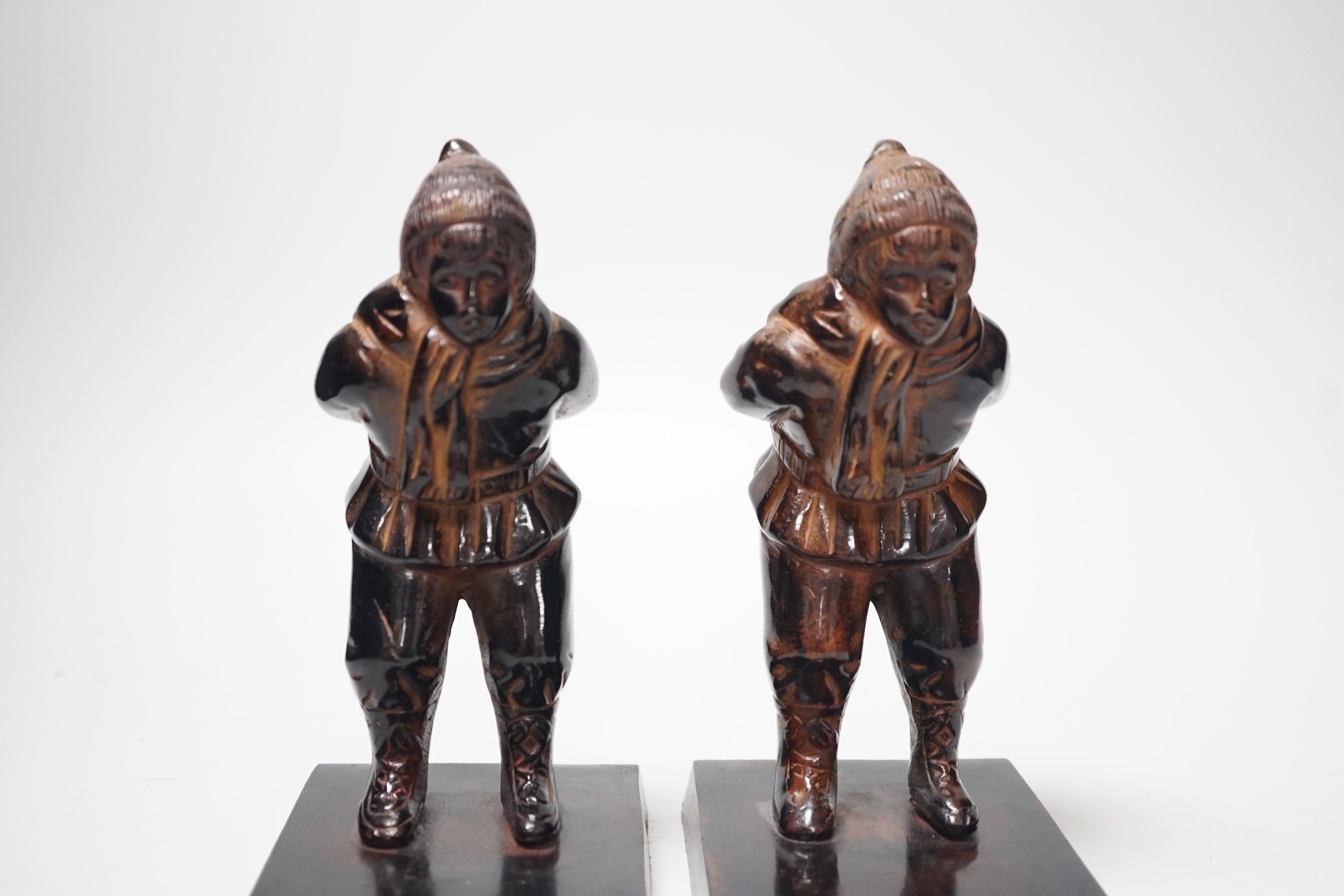 A pair of patinated metal figural bookends, 17cm